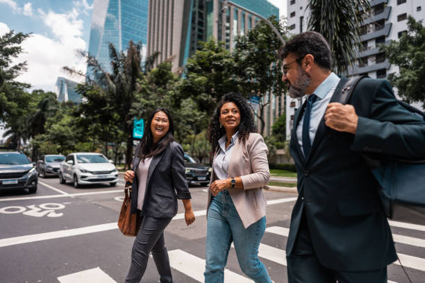 istock Coworkers talking while walking in the street 2023188536