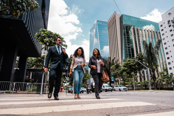 istock Coworkers talking while walking in the street 2023188541
