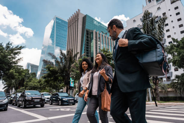 istock Coworkers talking while walking in the street 2023189045