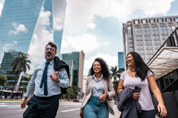 istock Coworkers talking while walking in the street 2023189605