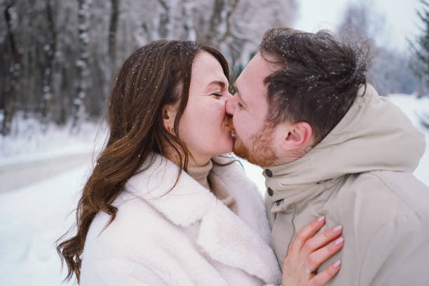 Loving couple on a snowy winter field. Happy together. Happy Valentine's Day