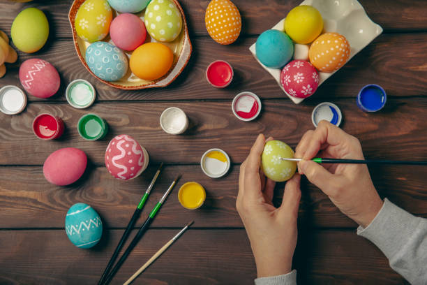 istock Easter egg painting at the kitchen table.Happy Easter celebration concept.Colorful Easter eggs with different patterns.Paints,decorations for coloring eggs for holiday.Creative background.Copy space 2023223840