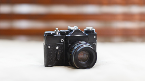 Analog retro film photo camera, manual lens, selective focus on SLR/ art concept.