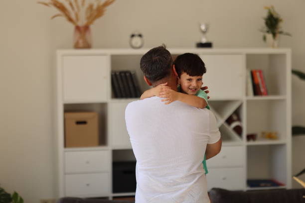 istock Affectionate little boy and his father embracing at home. 2023236448