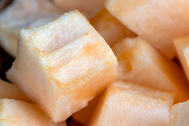 sliced orange melon close-up, delicious soft and ripe food melon on the table