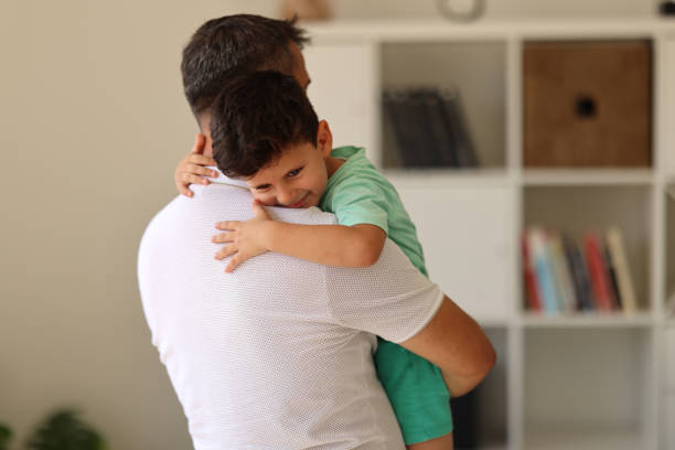 istock Affectionate little boy and his father embracing at home. 2023242445