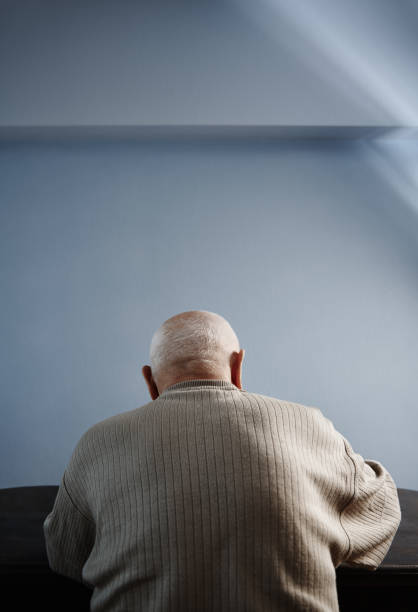 istock Back view on senior man sitting at the table 2023279047