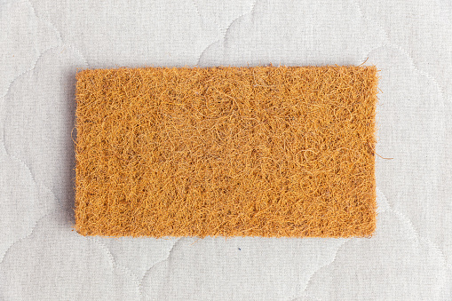 A rectangular sample of coconut coir used in the production of modern mattresses with independent spring blocks. Top view.