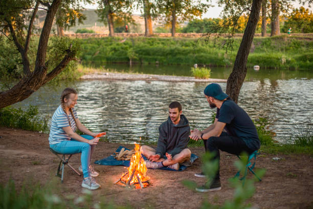 istock Young friends having fun in nature near a campfire 2023293840
