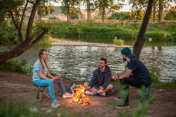 istock Young friends having fun in nature near a campfire 2023293845