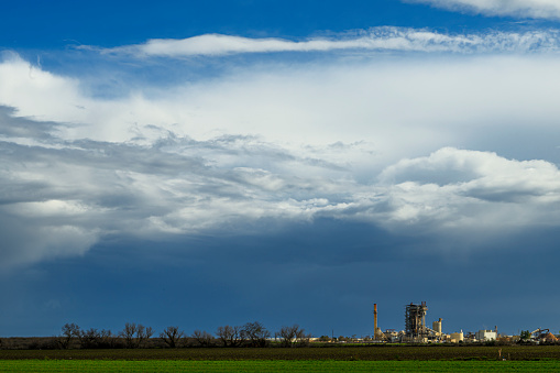 Wide view of storm clouds over the Sacramento Valley farmland.  In the background are the Sacramento River levees.

Taken in Sacramento, California, USA