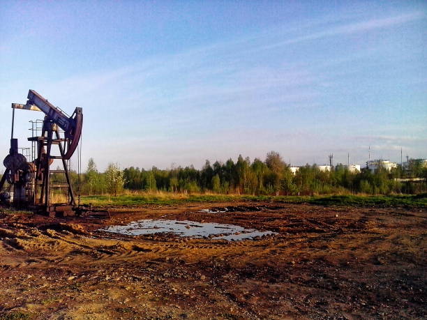 An oil pump jack operating in a rural landscape