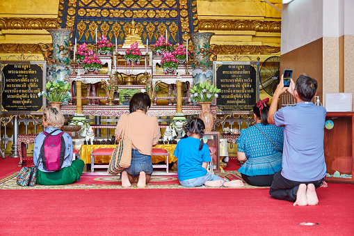 Bangkok, Thailand - August 26, 2023: people praying at Wihan Phra Mongkhon Bophit temple. Ayutthaya. Phra Nakhon Si Ayutthaya province. Thailand.