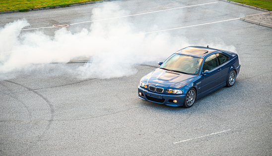 Lindesnes, Norway - October 15 2011: Blue BMW M3 E46 doing a burnout.