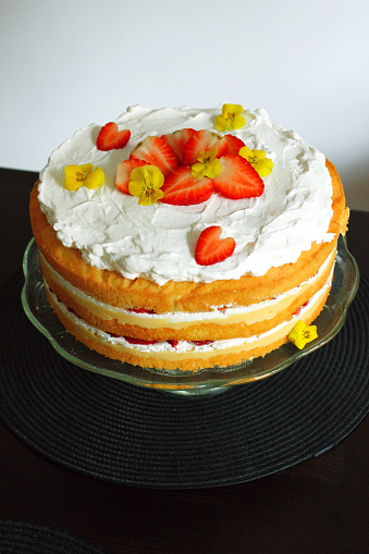 Cake with strawberries on top. Vanilla and strawberry flavor. Birthday time. Ready to serve.