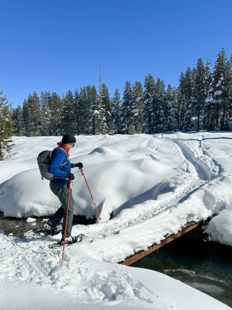 istock Fresh snowshoeing across bridge 2023364785