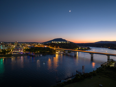 Aerial perspective of the Moon rising over the Tennessee River at sunset during Riverbed Music Festival in Chattanooga, Tennessee.