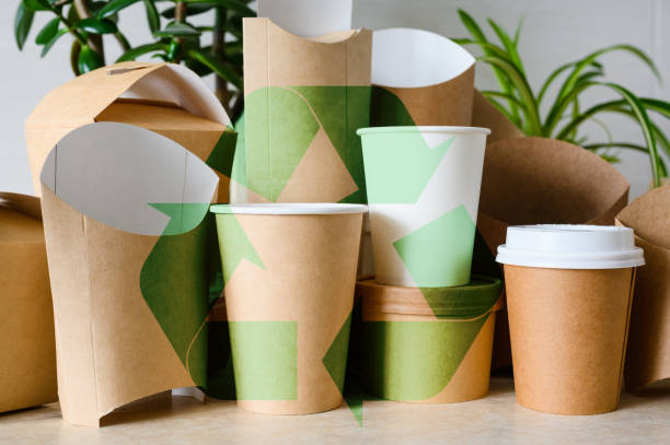 istock Large recycling sign on a background of paper disposable tableware. Zero waste and recycling concept 2023400540