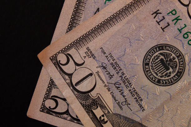 istock 50 dollar bills on black background 2023406806
