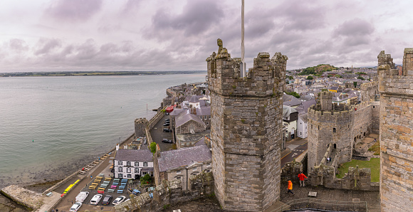 Caernarfon, United Kingdom - June 30, 2023 : A medieval fortress along the Menai Strait in north-west Wales - Caernarfon Castle