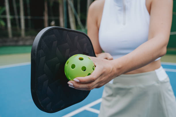 istock Woman serving pickleball game close-up on racket 2023551505