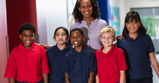 istock Teacher with middle school students in hallway 2023555207
