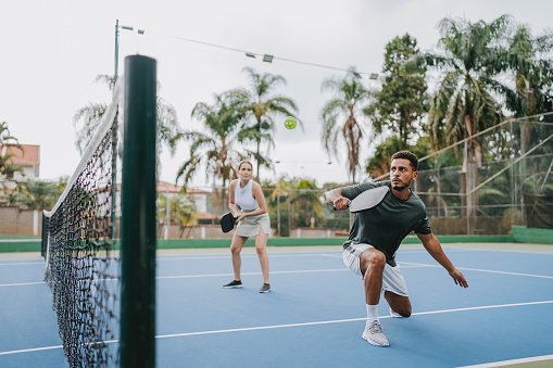 Two friends playing pickleball