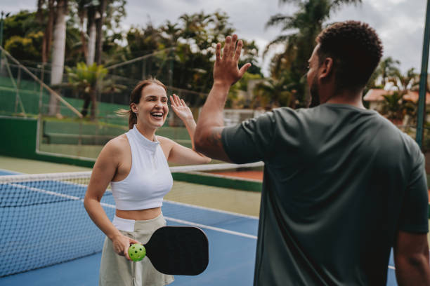 istock Couple playing pickleball celebrate point 2023559855