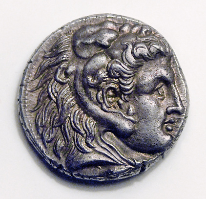 Ancient Greek  Tetradrachm of Philip III, a silver coin from my own collection minted in Ancient Babylon over two thousand years ago.\nHead of Herakles in a lion head dress with the face of Alexander the Great, 323-317 BC
