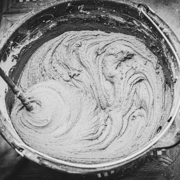 istock knead the solution with a mixer in a bucket of cement and sand 2023654080