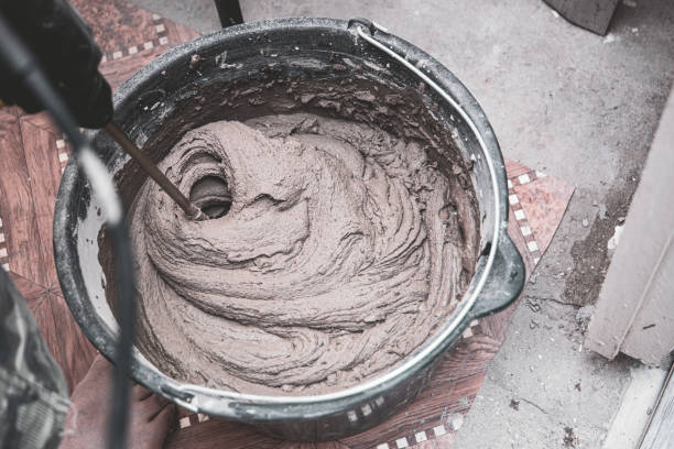 istock knead the solution with a mixer in a bucket of cement and sand 2023654082