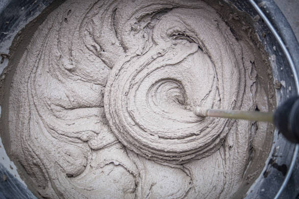 istock knead the solution with a mixer in a bucket of cement and sand 2023654084