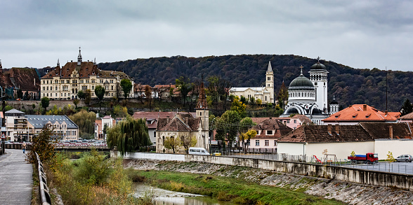 Ancient Sighisoara in Romania, panoramic view on old clock tower and medieval architecture heritage. Historic town with Dracula house and beautiful cityscape