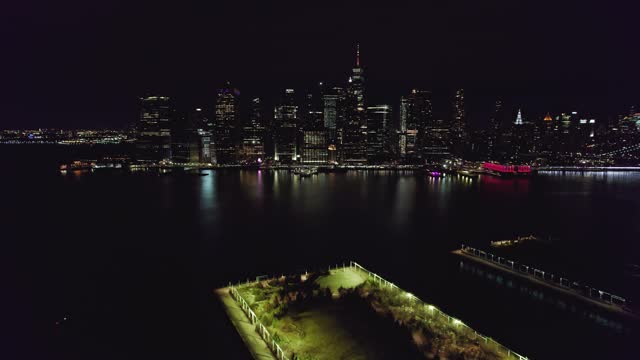 Lower Manhattan NYC from aerial establishing shot at night