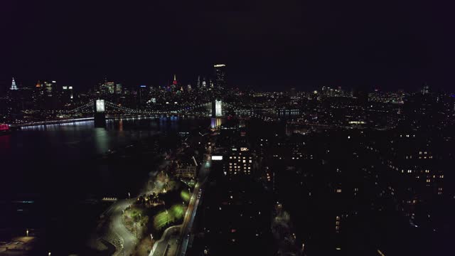 Lower Manhattan NYC from aerial establishing shot at night