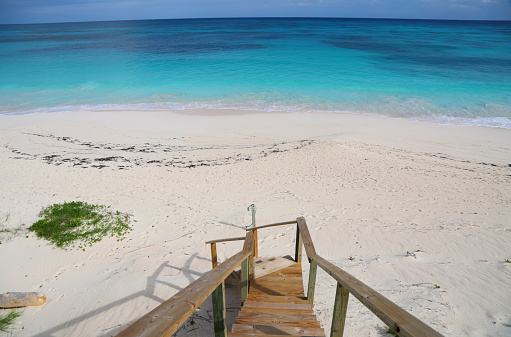 Steps leading down to a beach in the Bahamas at Elbow Cay.