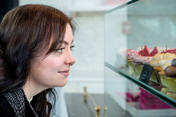 Decadent Delights: Young Professional Admires Cupcake Creations