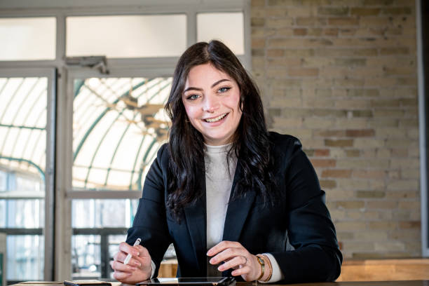 istock Efficiency in Action: Millennial Professional take a break from working to share a bright smile 2023709048