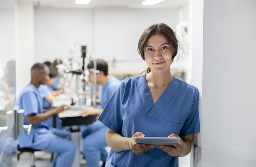 Portrait of a medical student using a digital tablet at medical school in an ophthalmology class - healthcare and medicine concepts