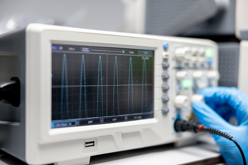 Close-up on a healthcare worker using an electrocardiography reader at the hospital