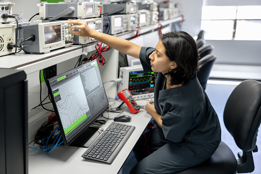 Latin American female engineer repairing medical equipment at the hospital - health technology concepts