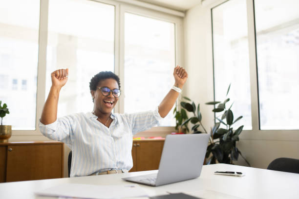 istock African-American female office employee using laptop 2023756036