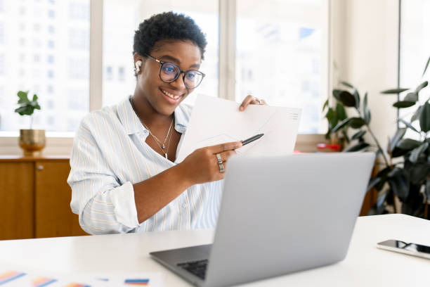 istock African-American female office employee using laptop 2023756037