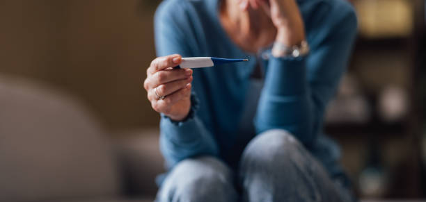 Woman Feeling Anxious While Looking at a Negative Pregnancy Test