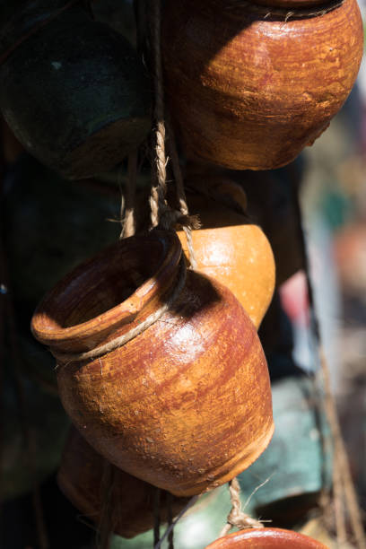 istock Sun highlights on yellow  ceramic jug  in pottery workshop 2023777970