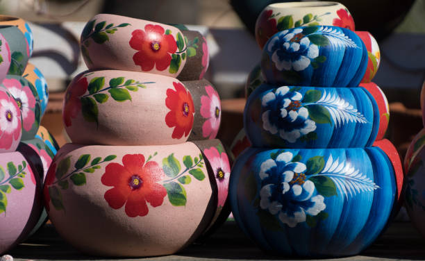 istock Stack of Mexican ceramic pots, blue and pink painted floral patterns 2023778487