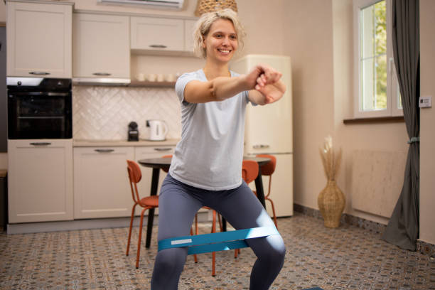 istock Young woman at home keeping fit by exercising 2023841360