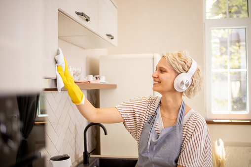 Young woman cleaning her home