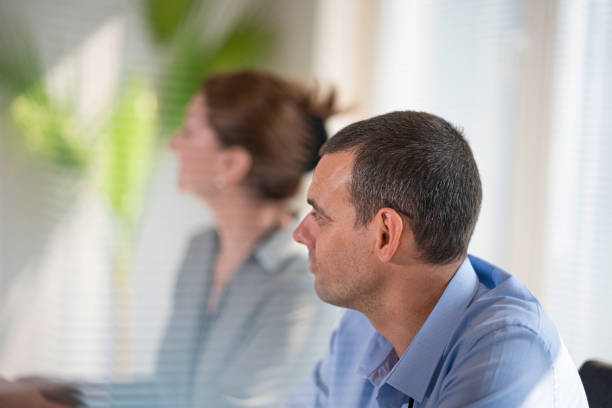 Business leader helping businessman at work