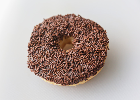 Close-up shot of Chocolate Sprinkle Donut from top view in white background
